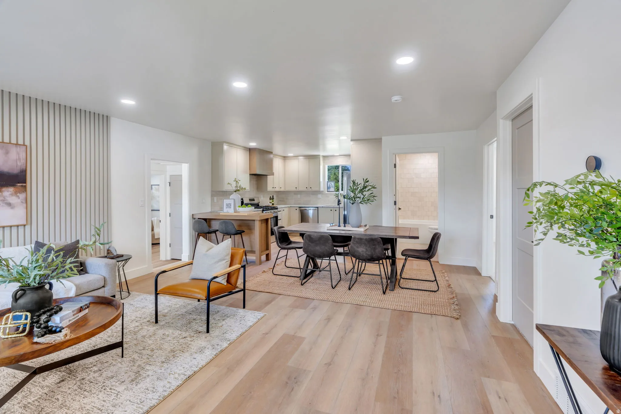Open-concept living space featuring wood-finish flooring throughout
