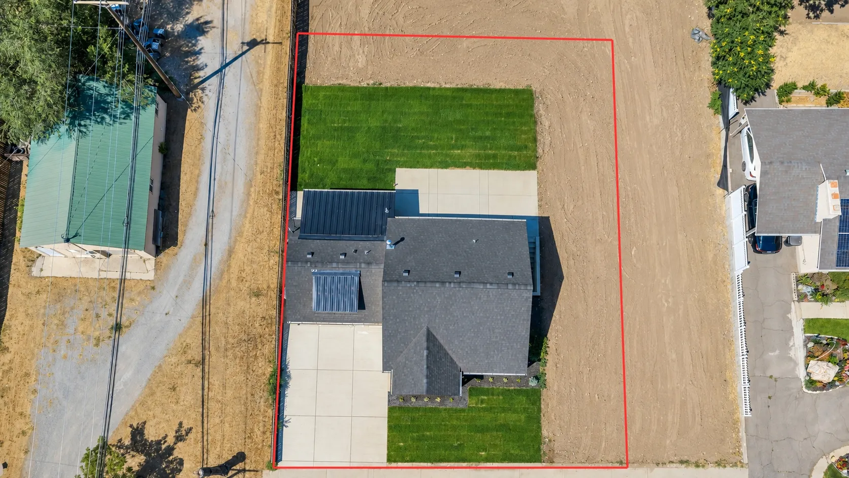 Aerial perspective showcasing a property with a distinct red boundary line