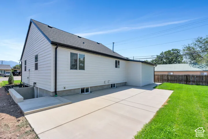Expansive concrete patio with a manicured lawn area