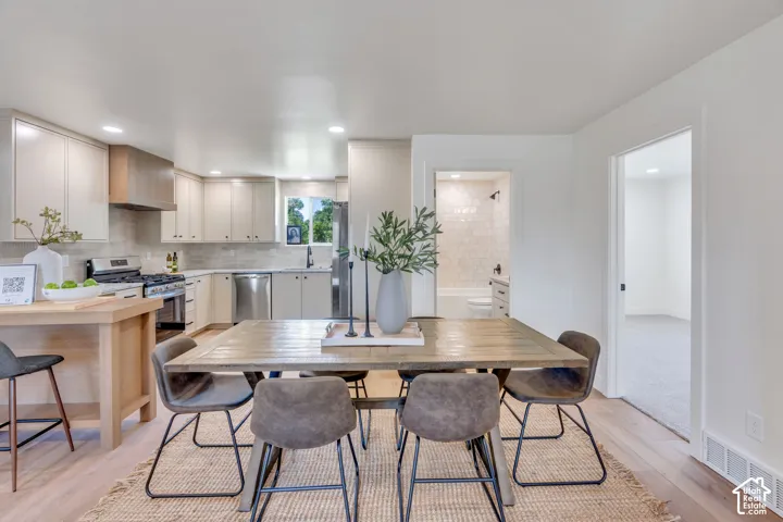 Open-concept living area with wood-finish flooring extending into the kitchen