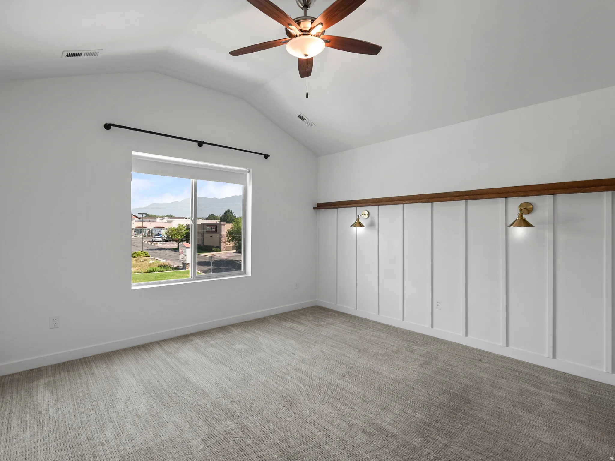 Vaulted ceiling featuring a ceiling fan with integrated lighting