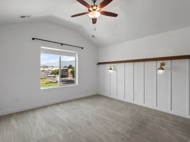 Vaulted ceiling featuring a ceiling fan with integrated lighting