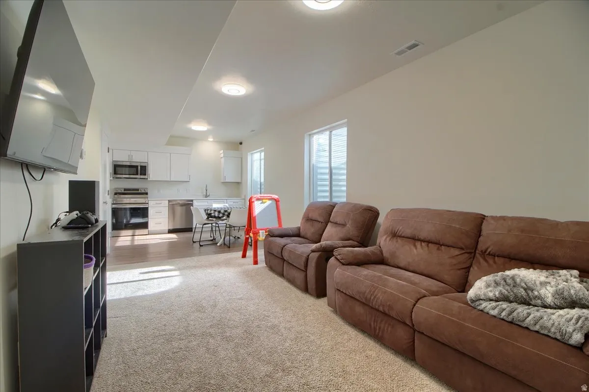 Finished basement space featuring recessed lighting and carpeted flooring
