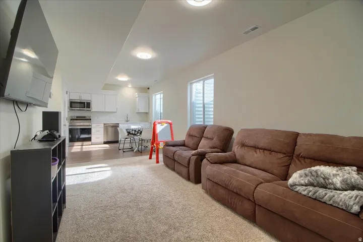 Finished basement space featuring recessed lighting and carpeted flooring