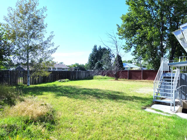 Expansive lawn area with a full privacy fence