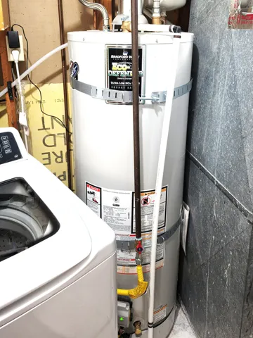Modern water heater with visible gas line and pressure relief valve
