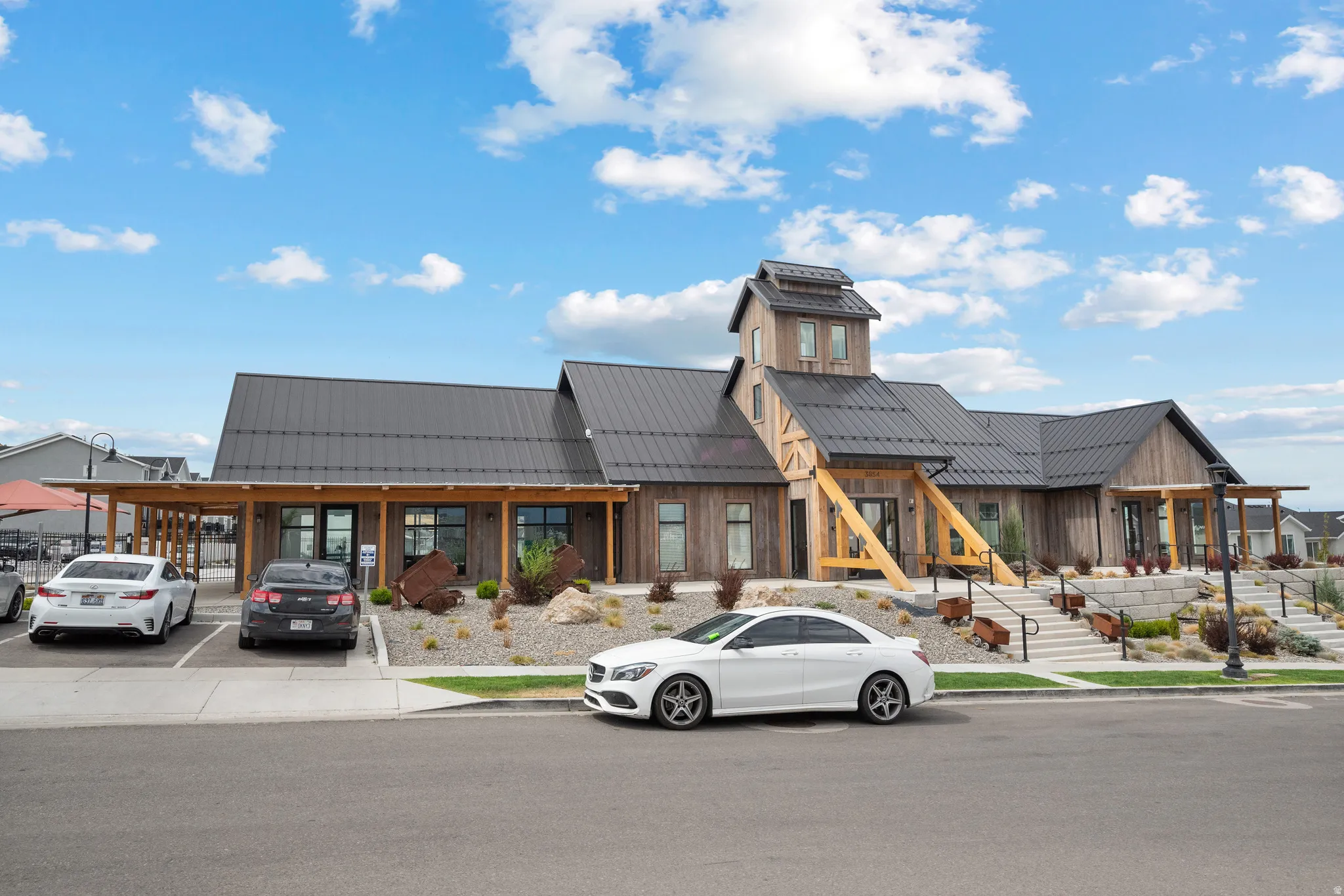 Modern Community building with a dark metal roof and wood siding