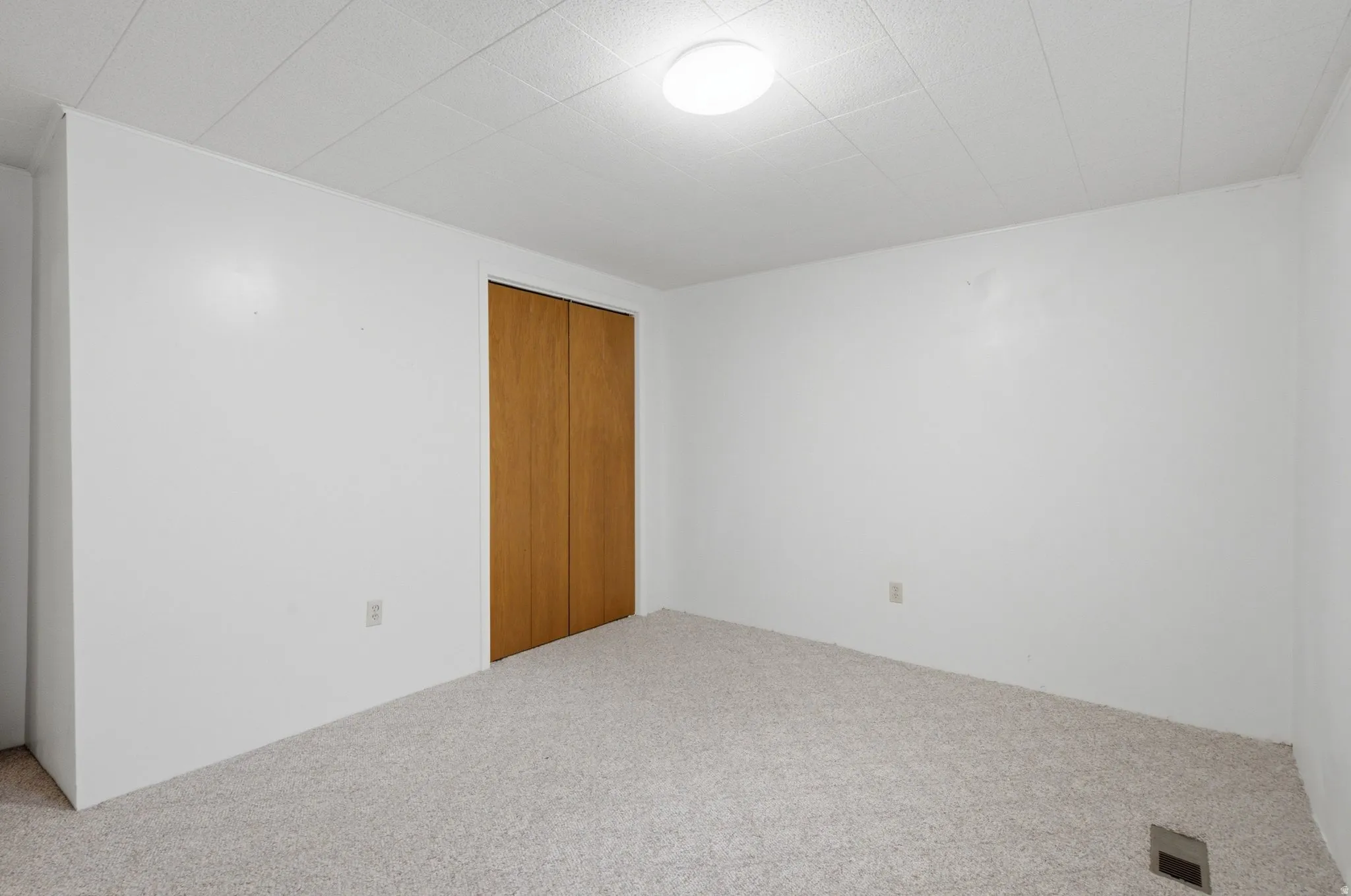 Room featuring light-toned carpeting and white walls