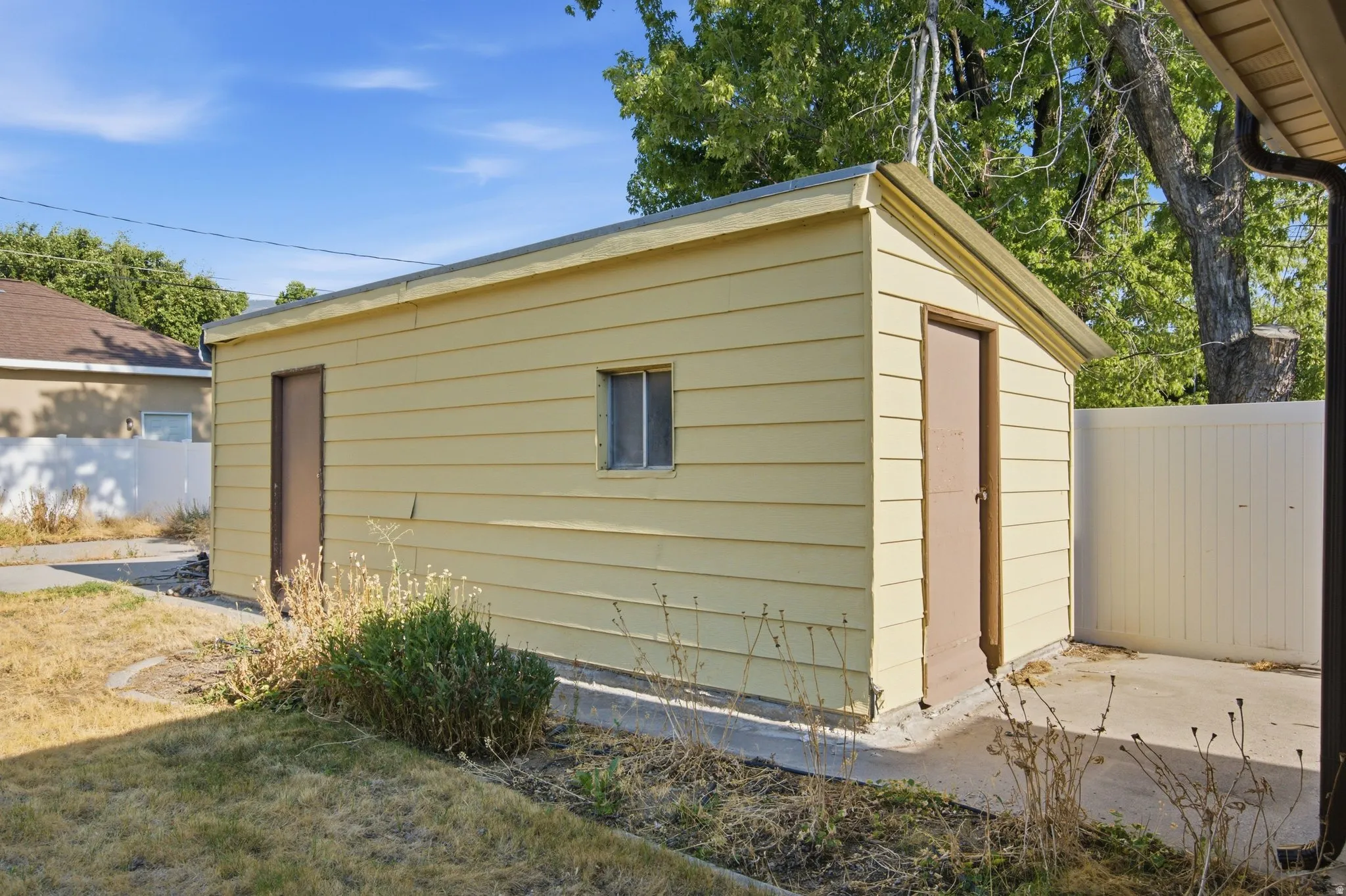 Detached storage shed with two access doors and a single window
