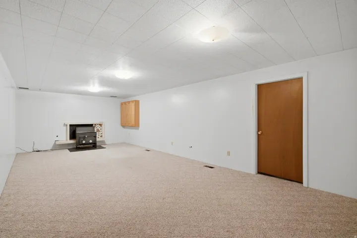 Spacious room featuring neutral carpeting and white walls