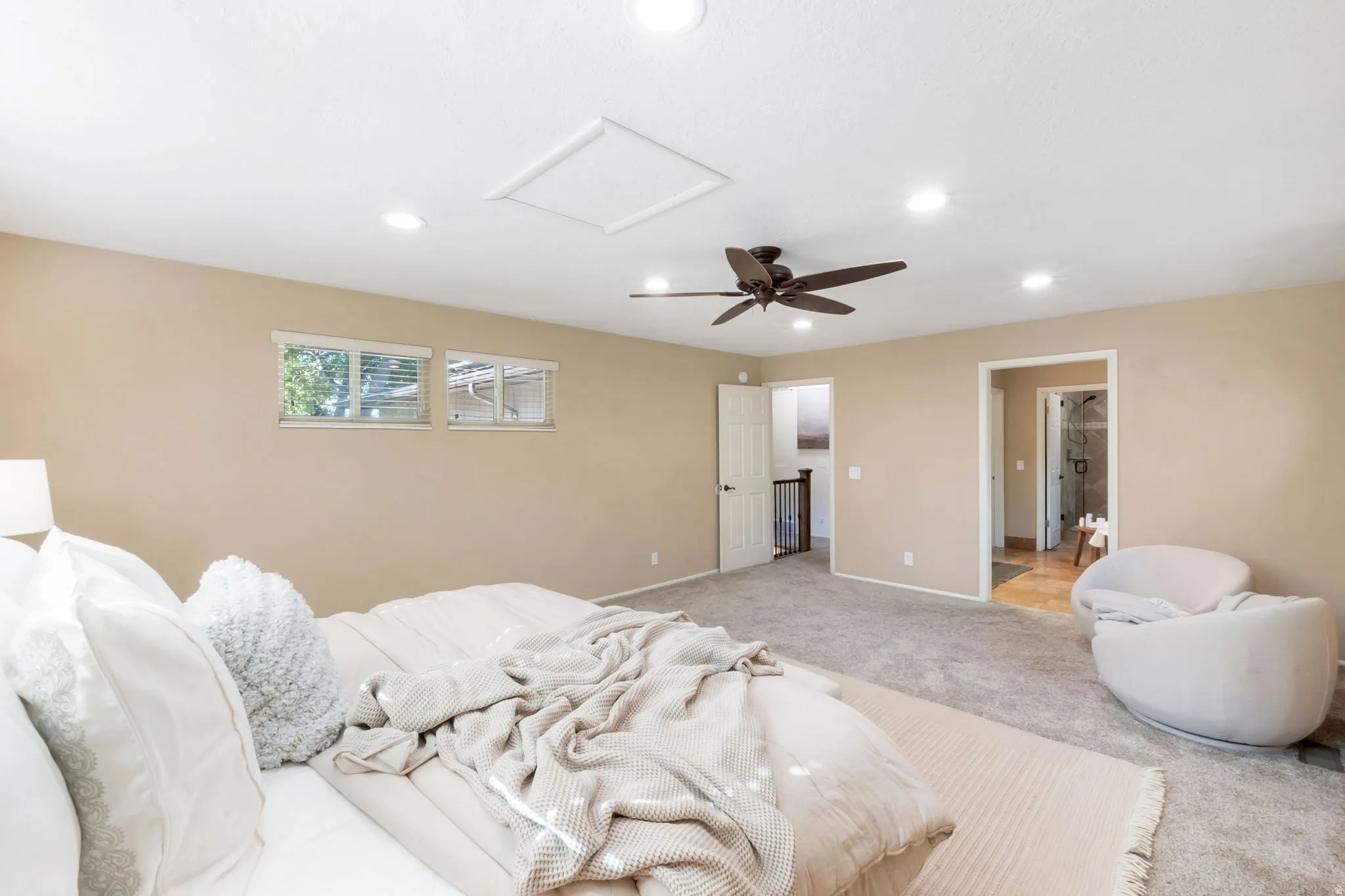 Spacious room with plush carpeting and light beige wall paint