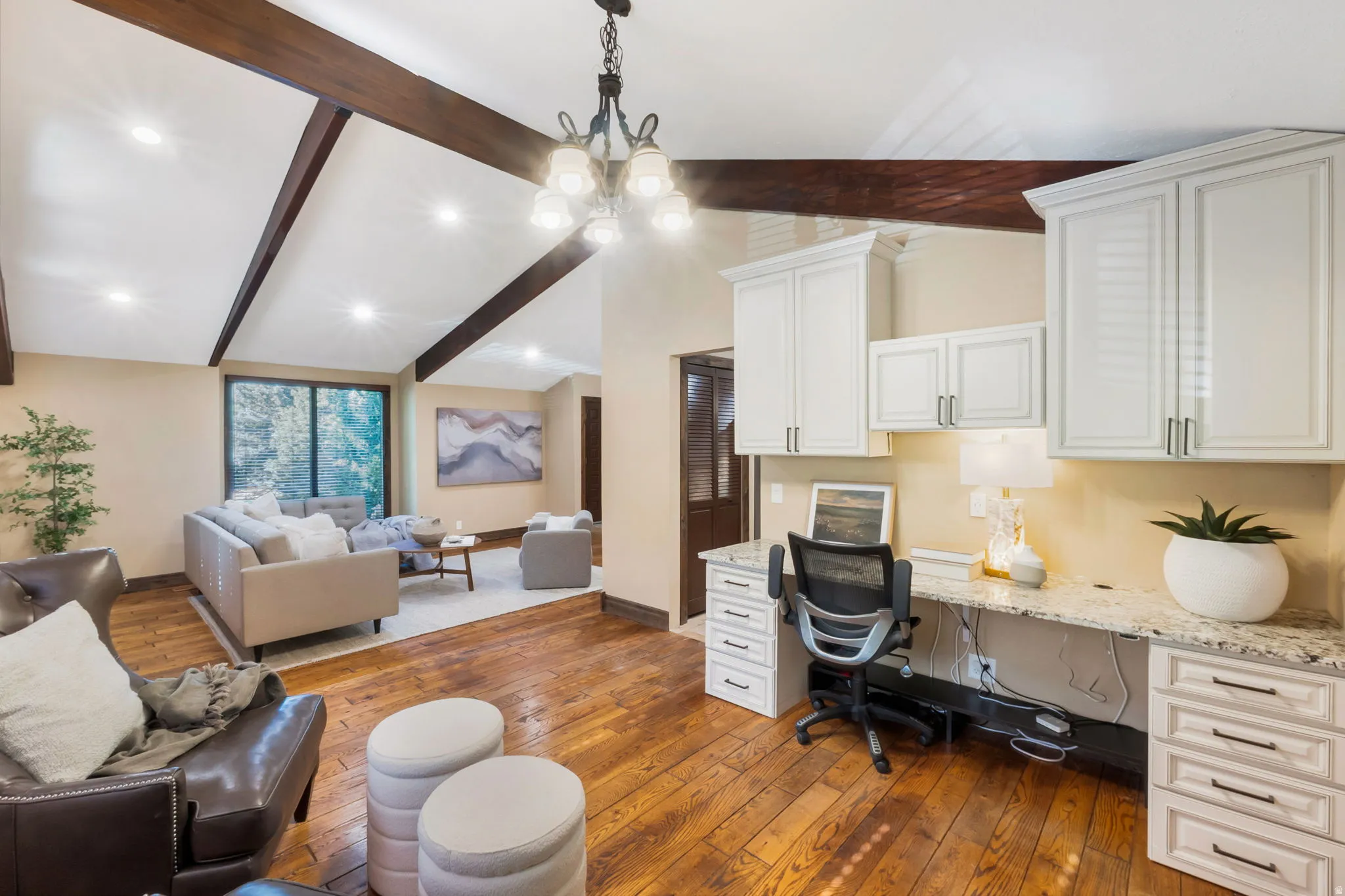 Integrated desk area featuring white cabinetry and a speckled countertop