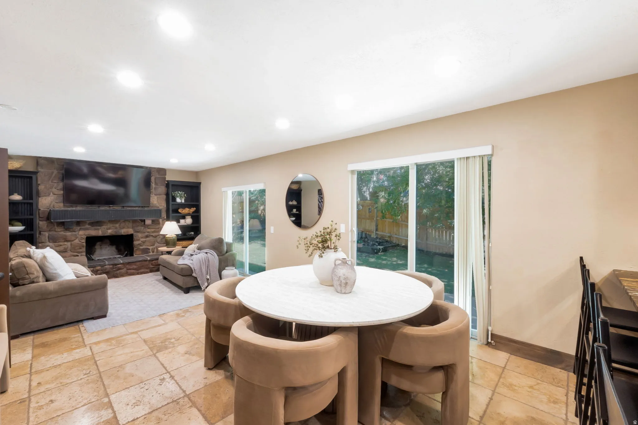 Open-concept living area featuring stone-finish flooring and recessed lighting