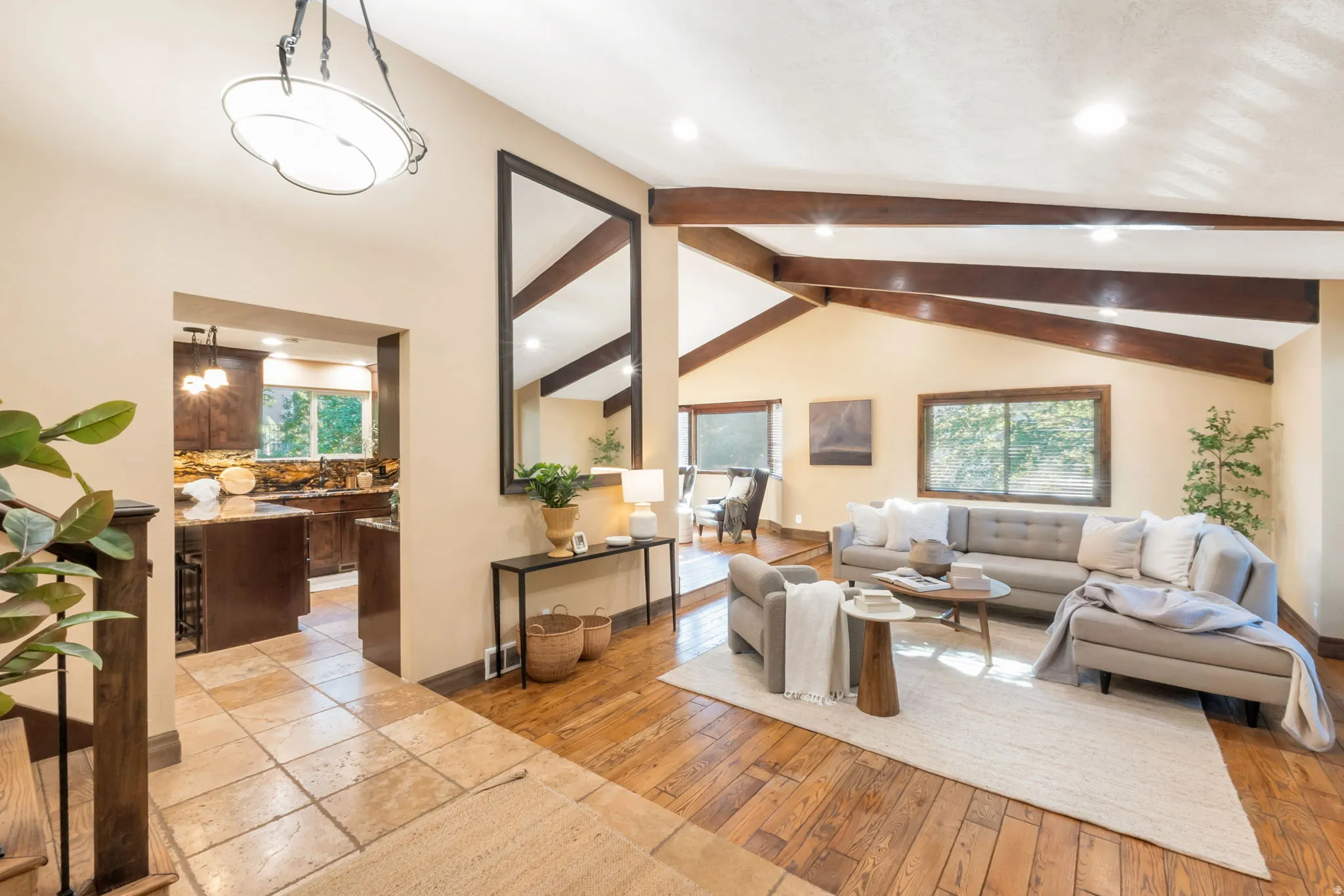 Vaulted ceilings with exposed wood beams define this spacious living area
