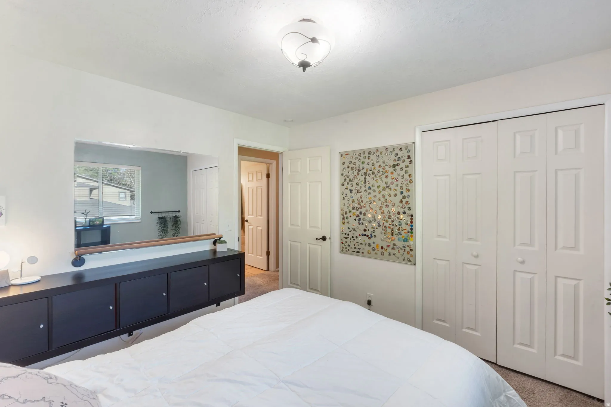 Bedroom featuring white walls and neutral-toned carpeting