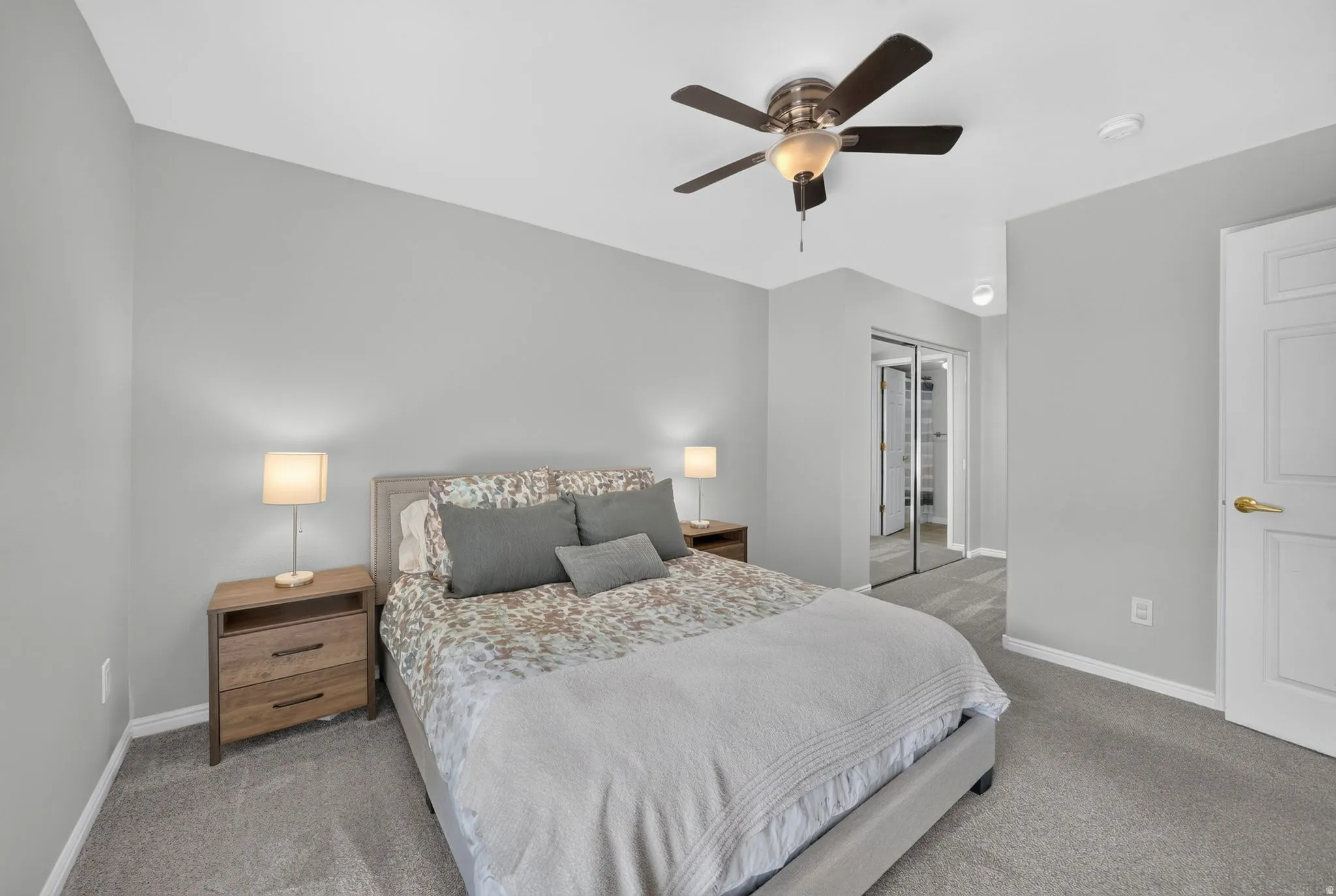 Plush gray carpeting throughout, complemented by light gray wall finishes
