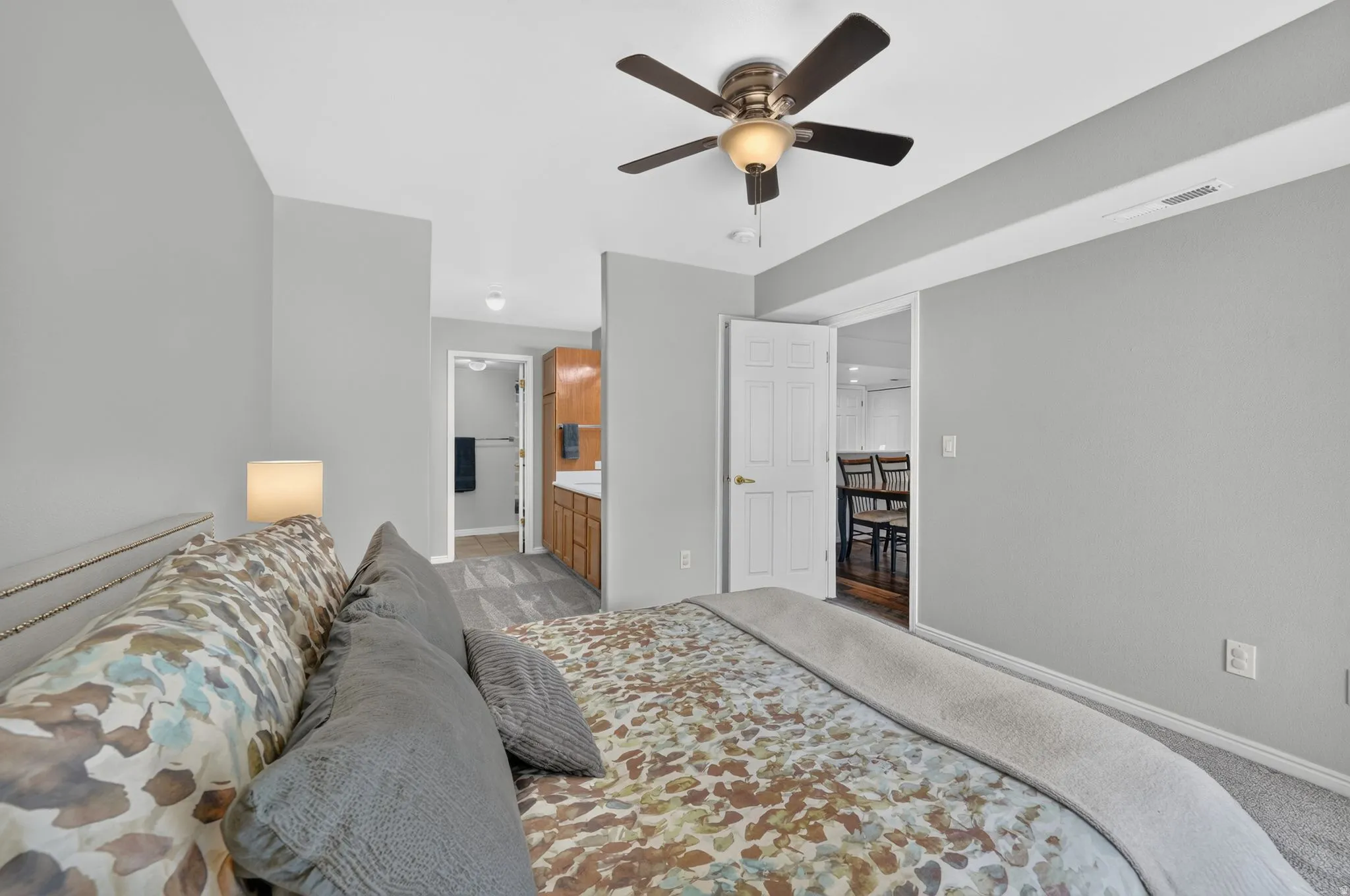 Bedroom featuring light gray wall paint, carpeting, and a ceiling fan with integrated lighting