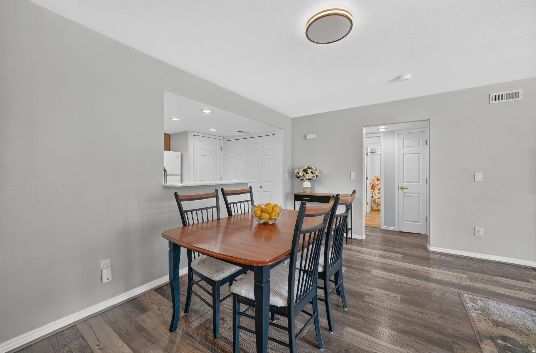 Dining area featuring wood-finish flooring and light gray wall paint