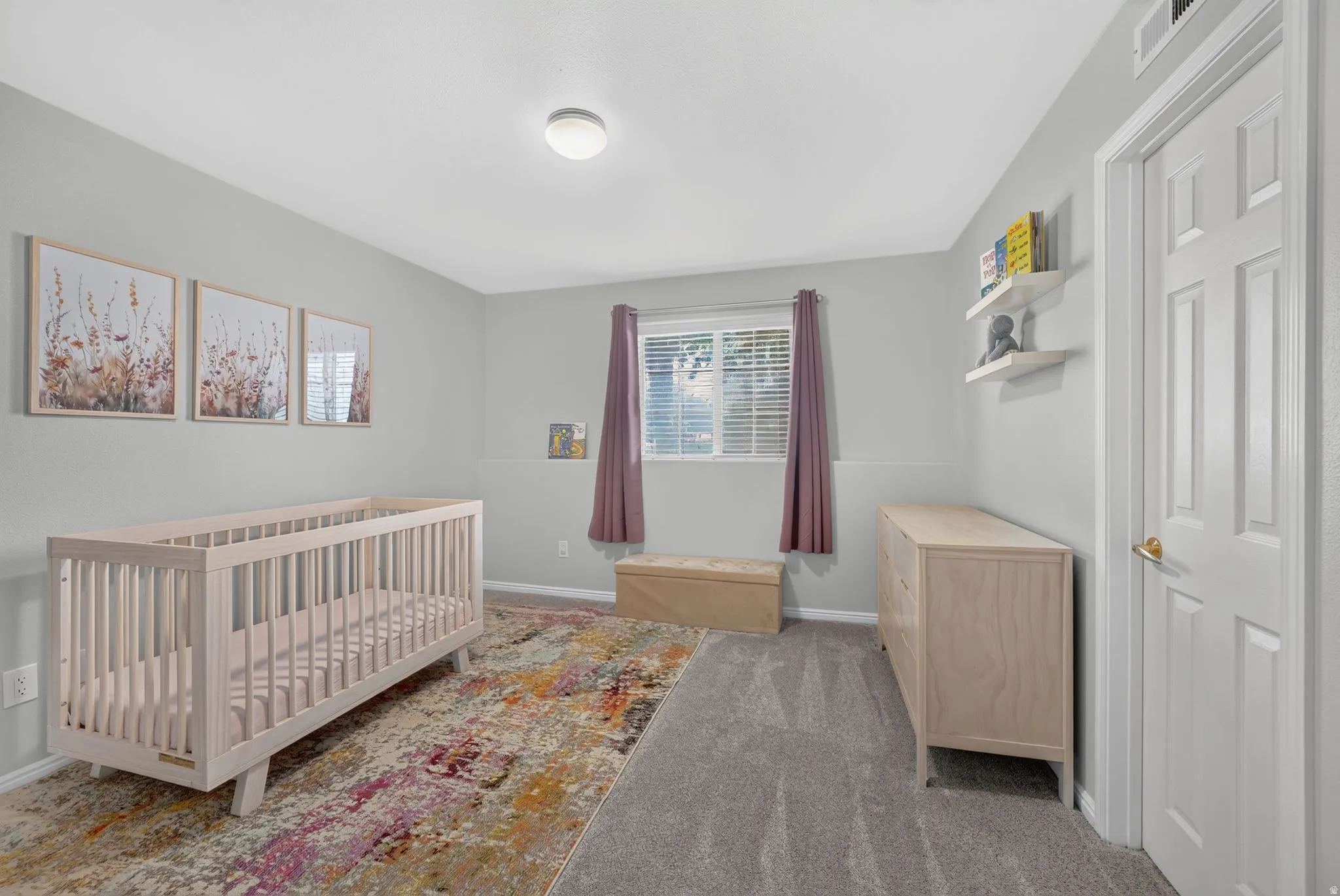 Bedroom featuring light gray walls, a window with horizontal blinds, gray carpeting, and a white six-panel door