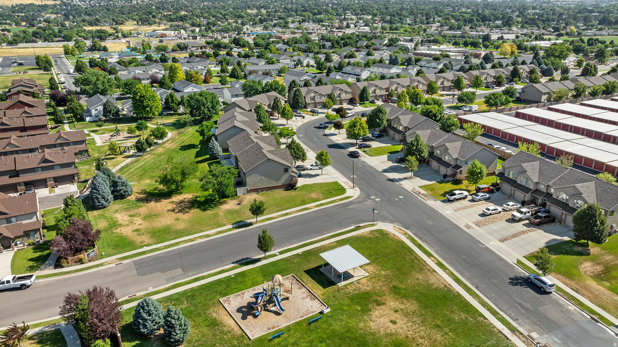 Expansive community featuring multiple residential buildings, paved roadways, and integrated green spaces