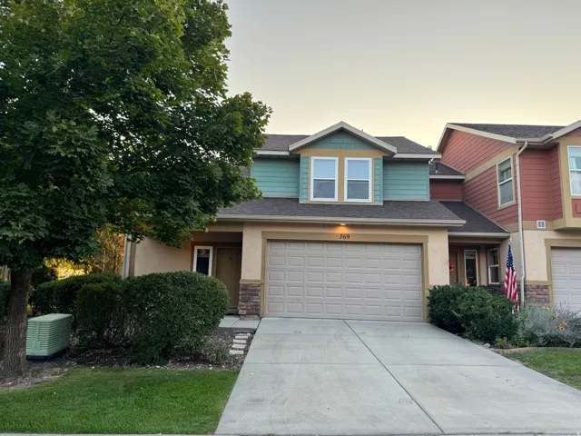 Two-story residence featuring stucco and siding exterior finishes, an attached two-car garage, and a concrete driveway