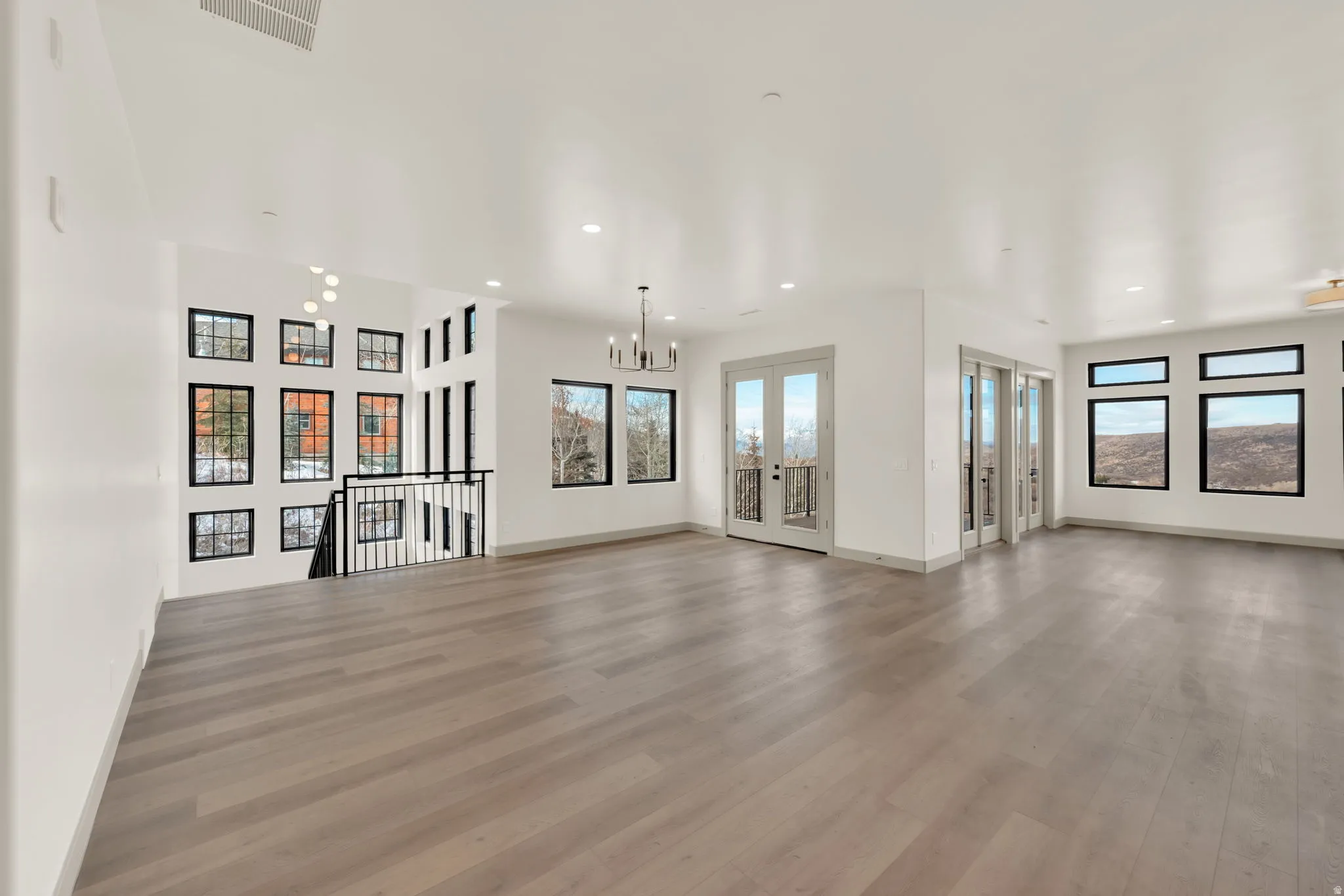 Great room with impressive stairway leading down to walk-out basement