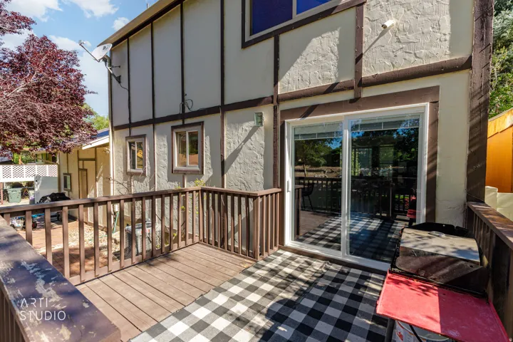 Expansive outdoor deck featuring wood-finish flooring and a wood railing system