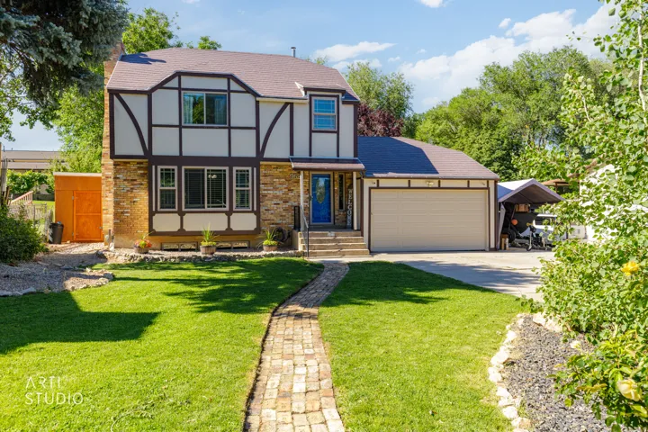 Tudor-style home featuring a distinctive half-timbered exterior with stone accents and multi-pane windows