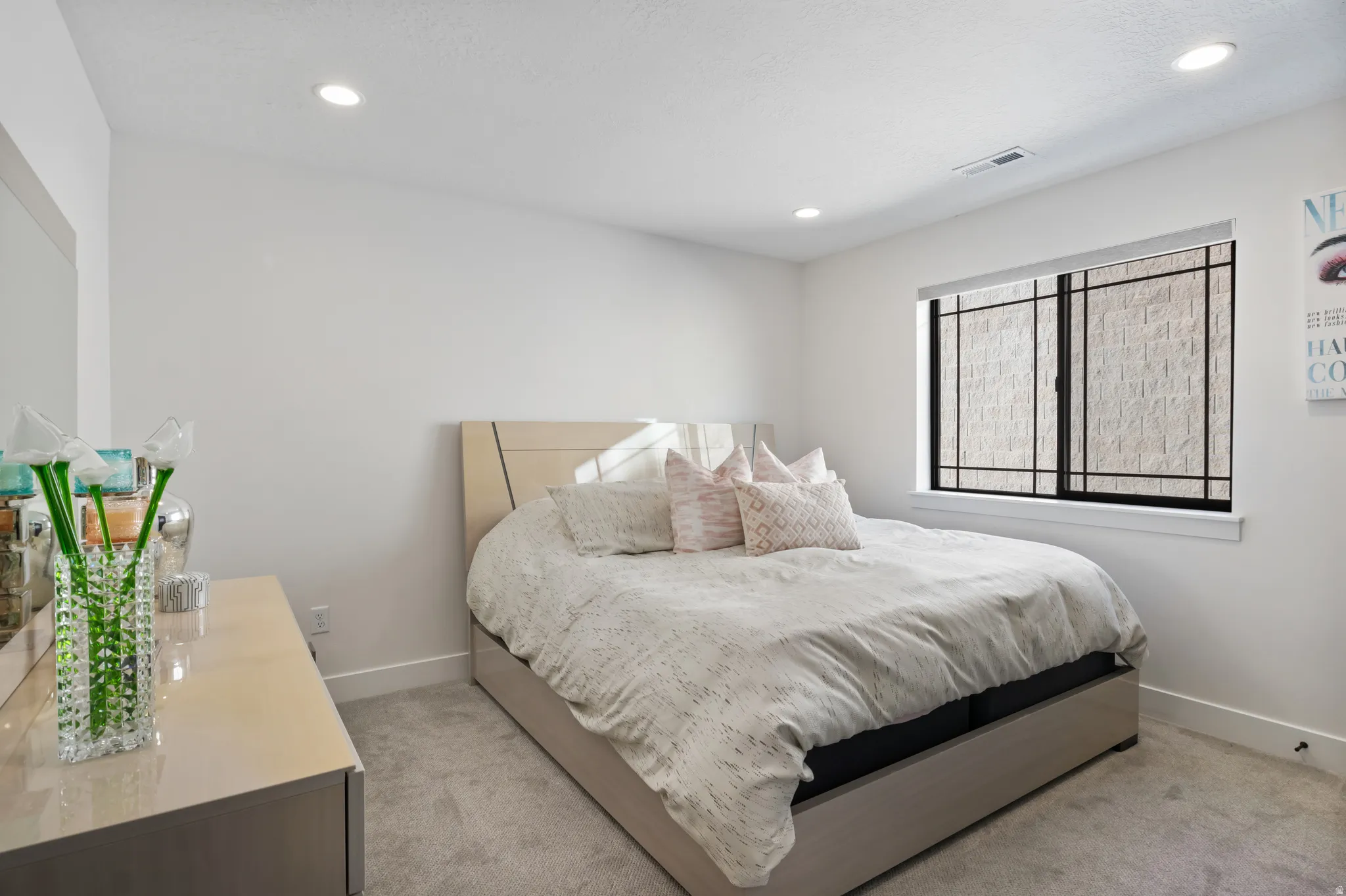 Carpeted room featuring recessed lighting, a window with dark framing, and light-colored walls