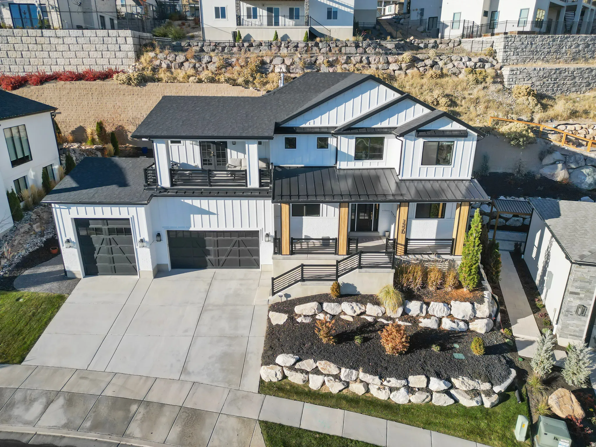 Modern farmhouse exterior with white vertical siding and black trim