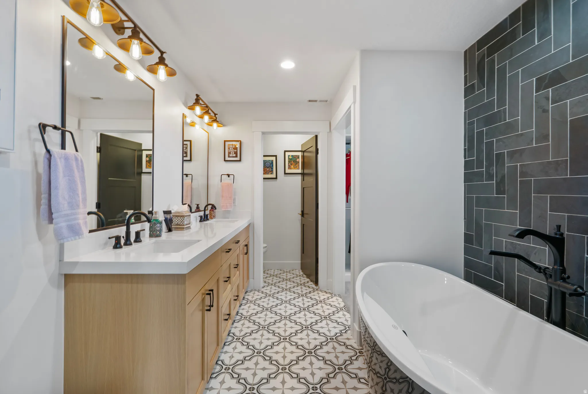 Freestanding soaking tub with floor-mounted faucet
