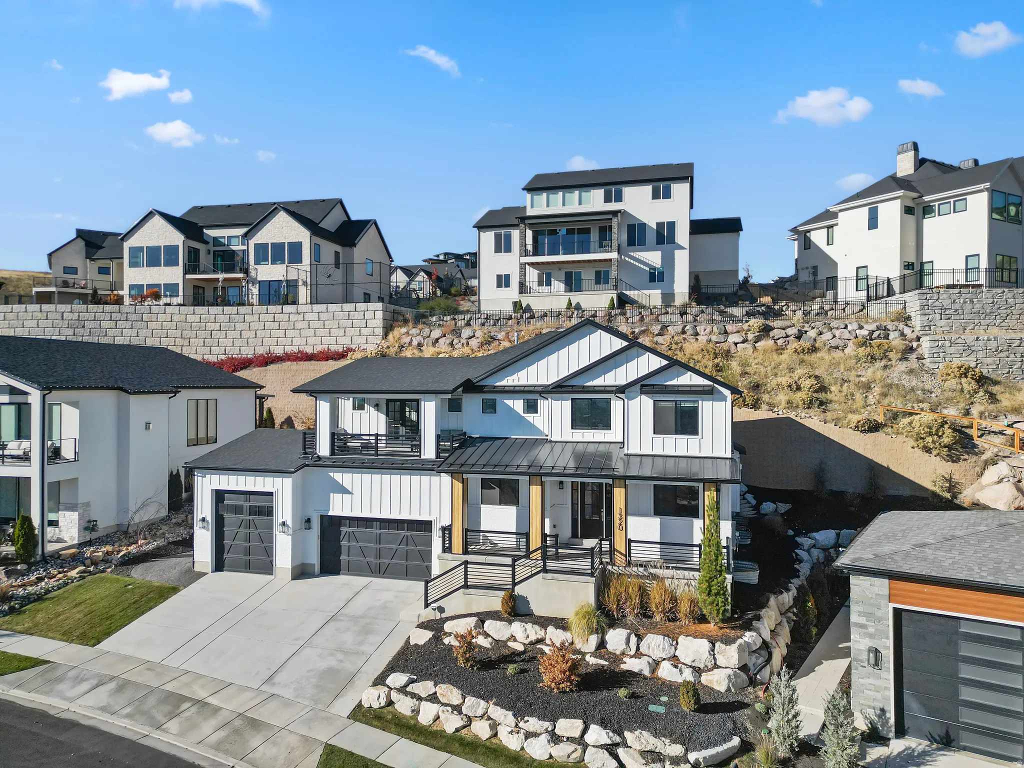 Contemporary two-story residence with white vertical siding and black trim accents