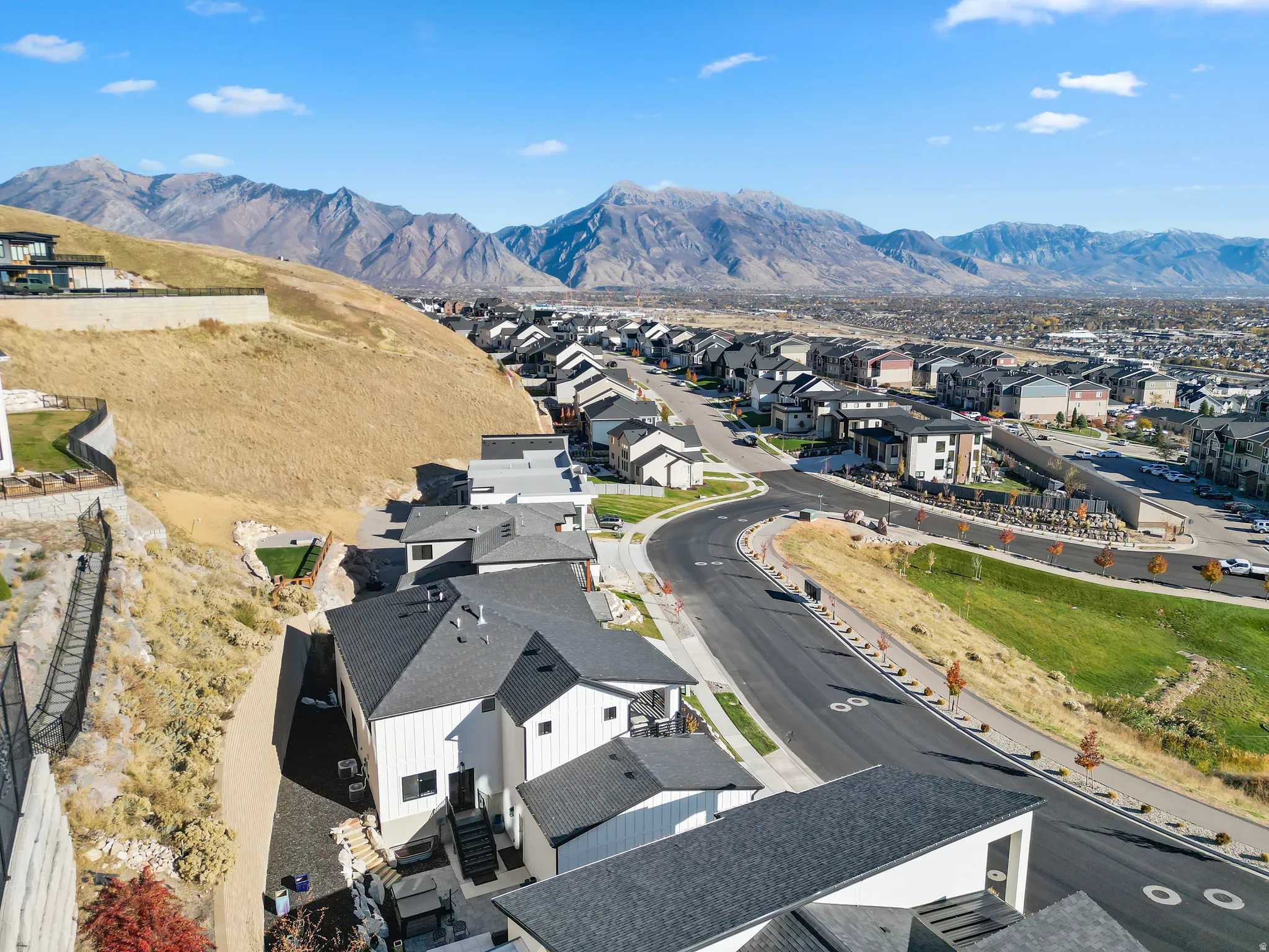 Aerial perspective showcasing a developed residential area with a mountain range backdrop