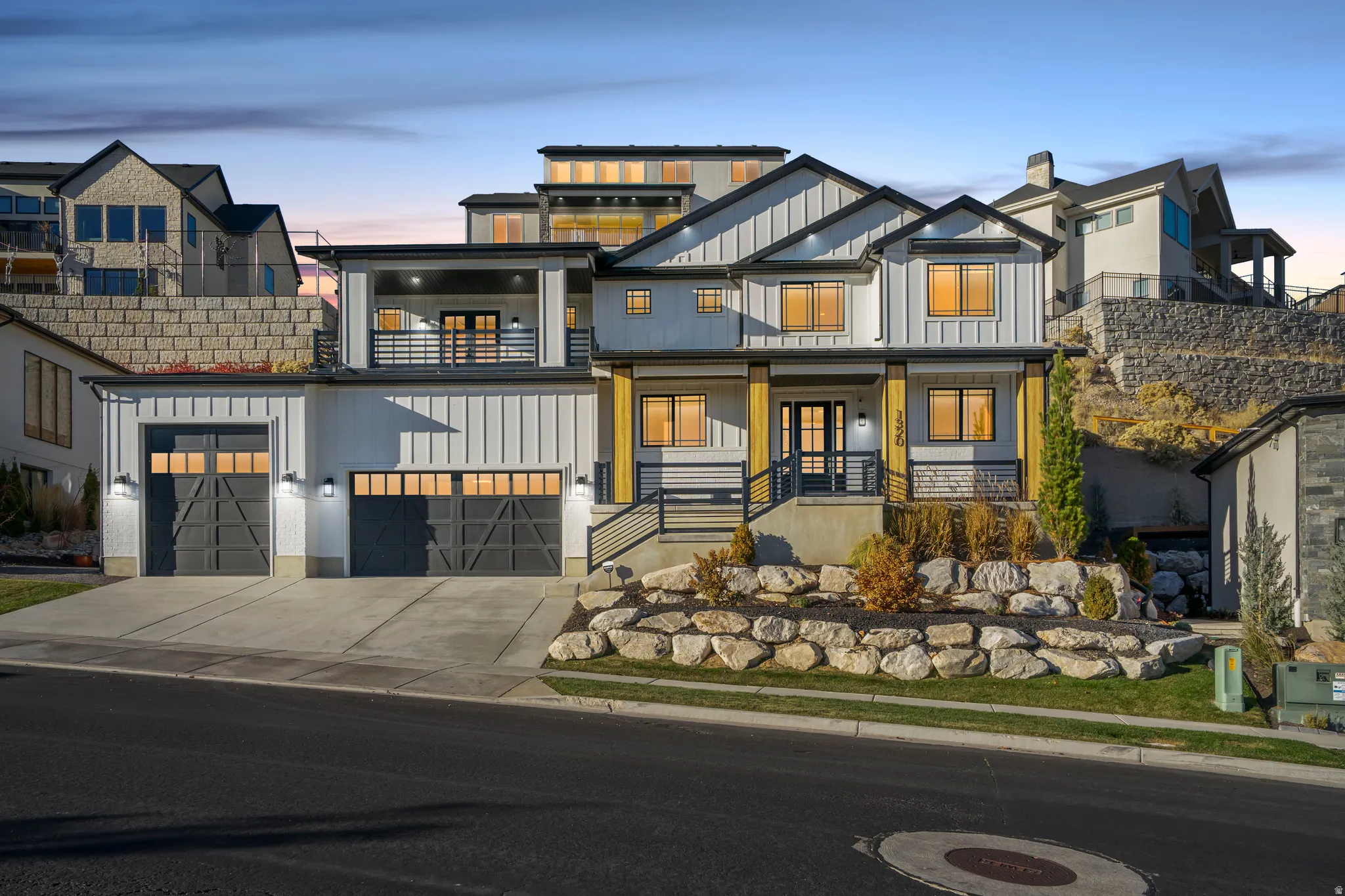 Contemporary home featuring board and batten siding with stone accents