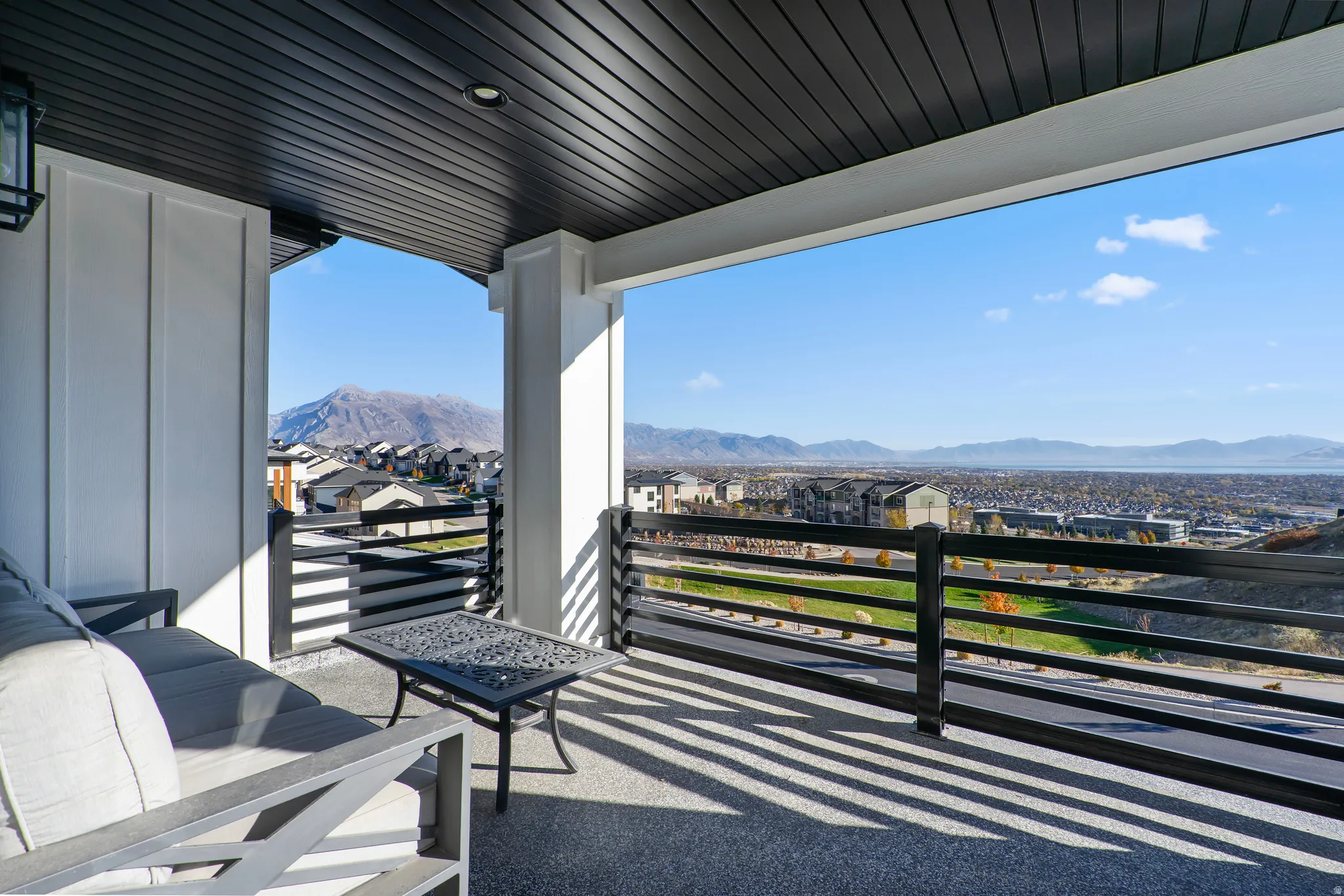 Covered outdoor balcony with mountain and distant water scenery