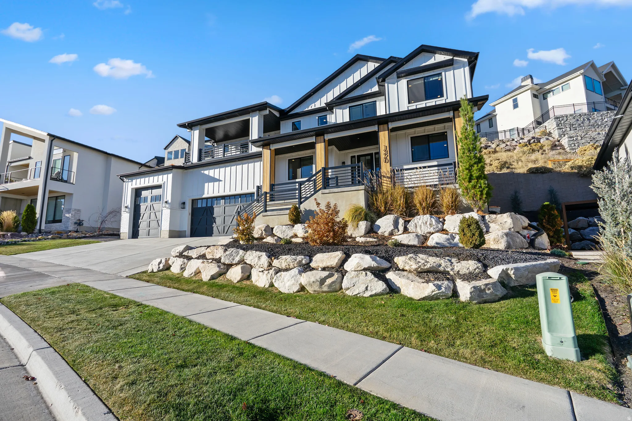 Modern dwelling featuring a white vertical board and batten facade with black trim accents