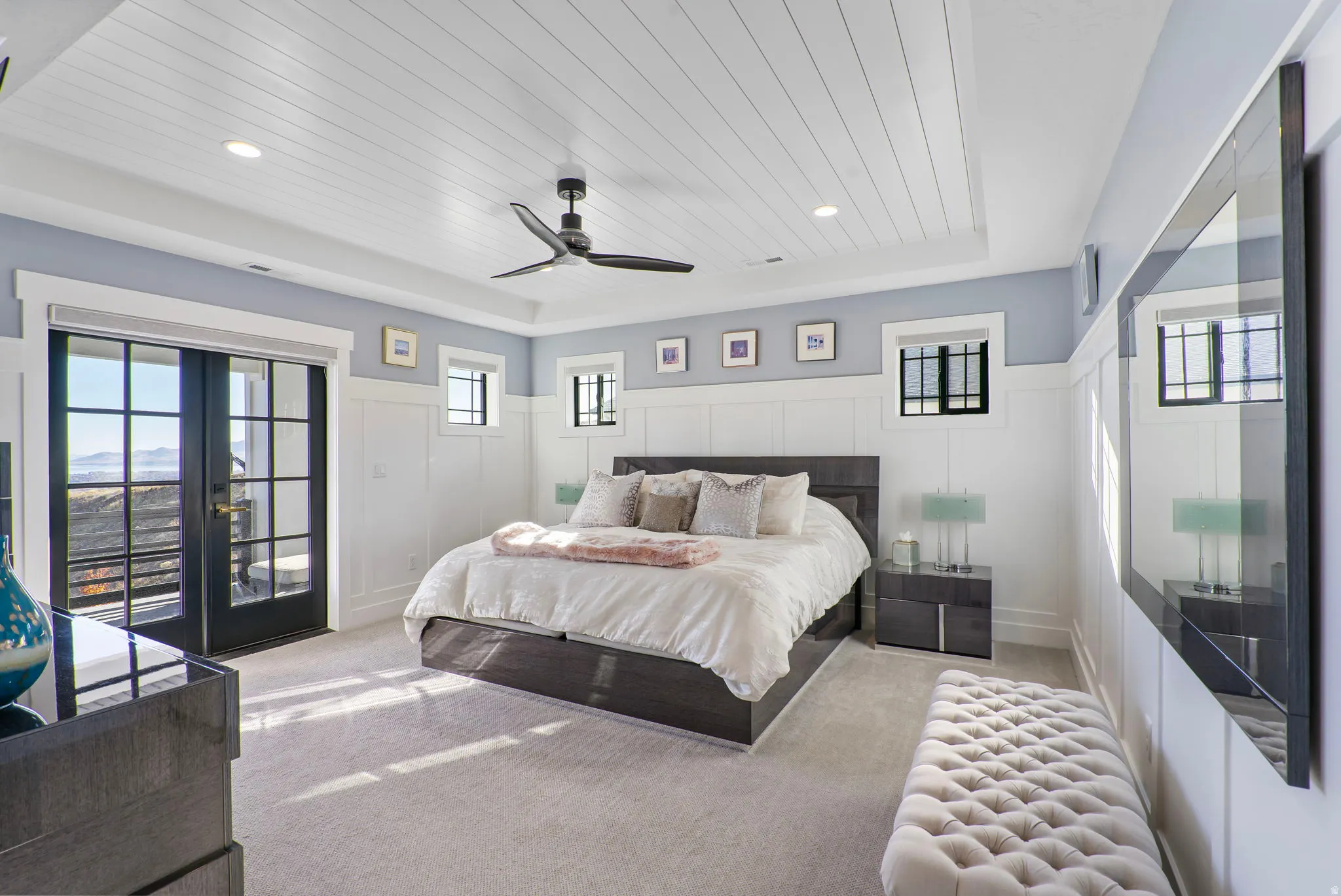 Spacious primary bedroom suite with vaulted shiplap ceiling, ceiling fan, and recessed lighting throughout