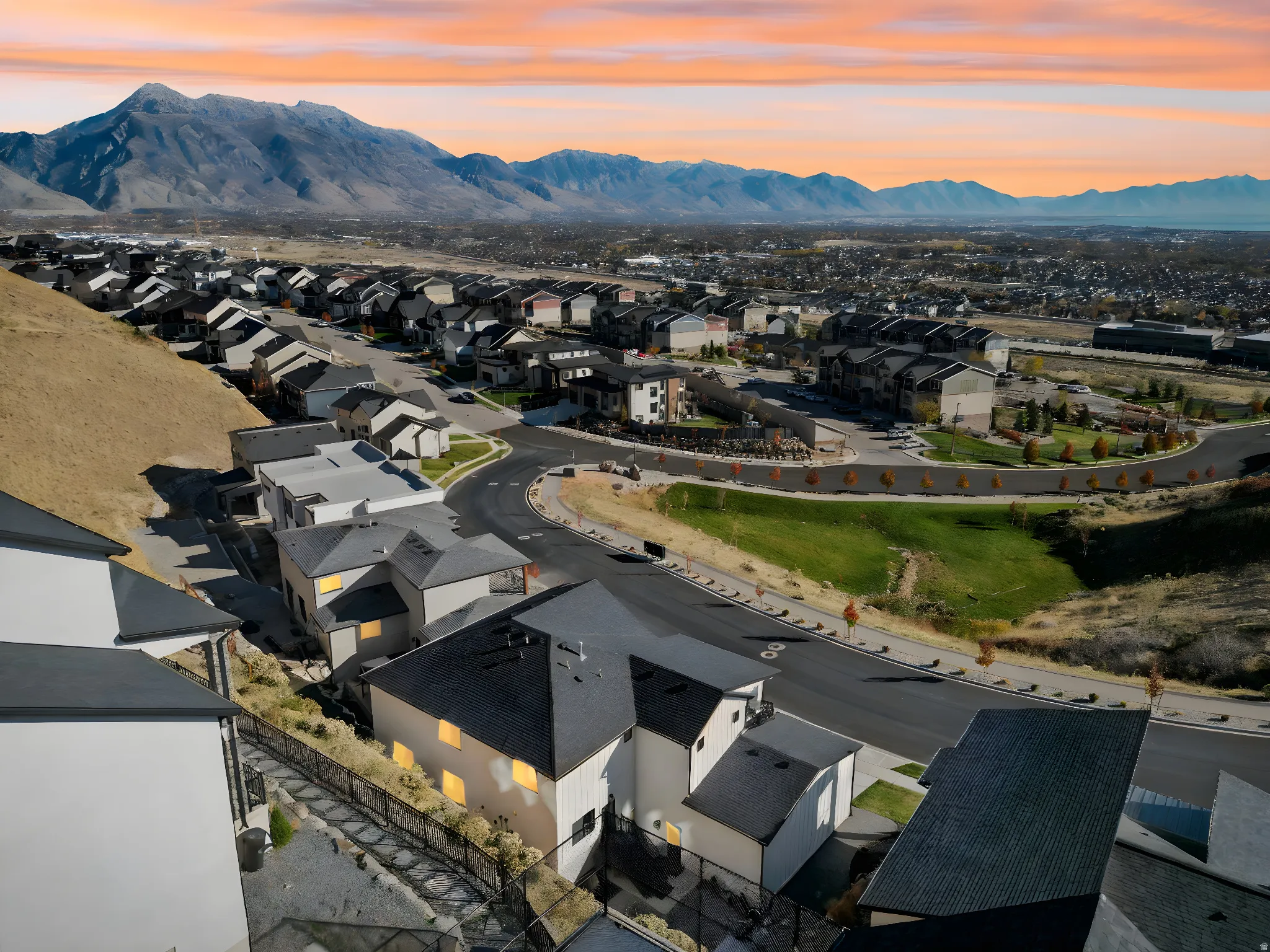 Sweeping mountain backdrop frames a residential community with varied architectural styles