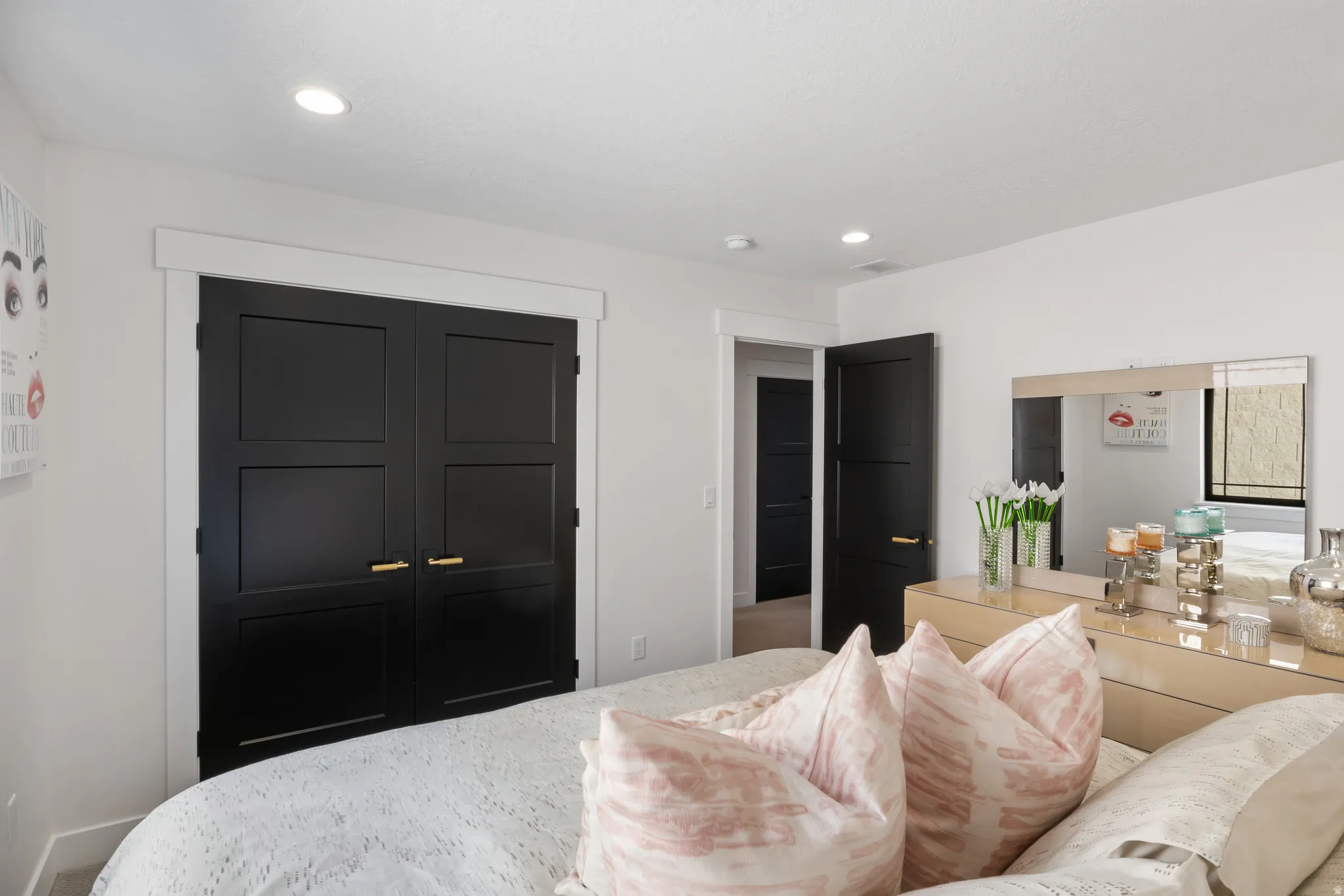 Recessed lighting illuminates the space, featuring white walls and trim throughout