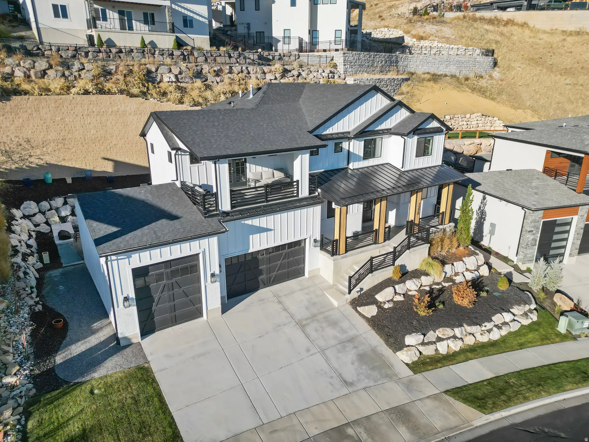 Contemporary home featuring white board and batten siding with black trim accents