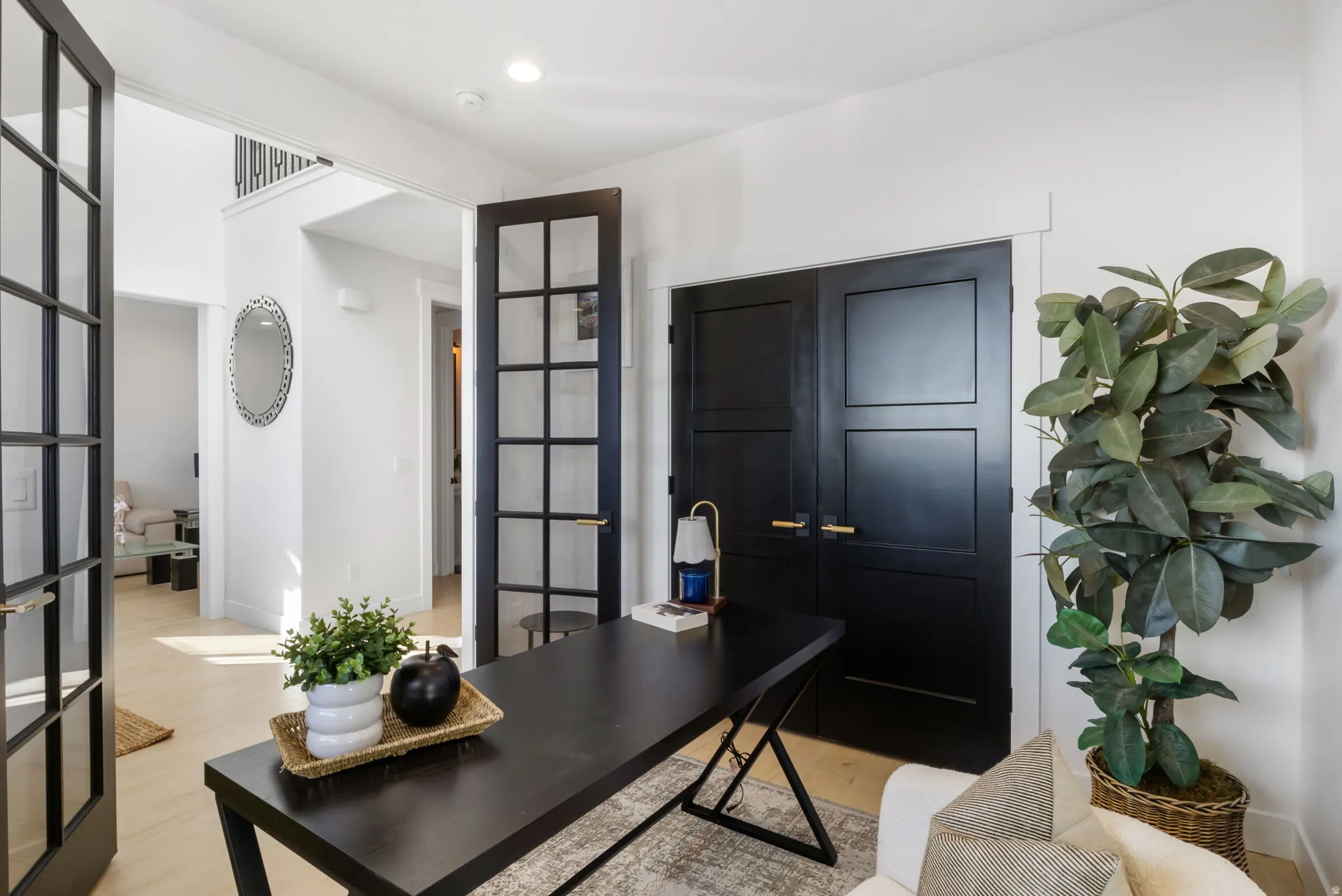 Modern interior featuring light wood-finish flooring and white walls