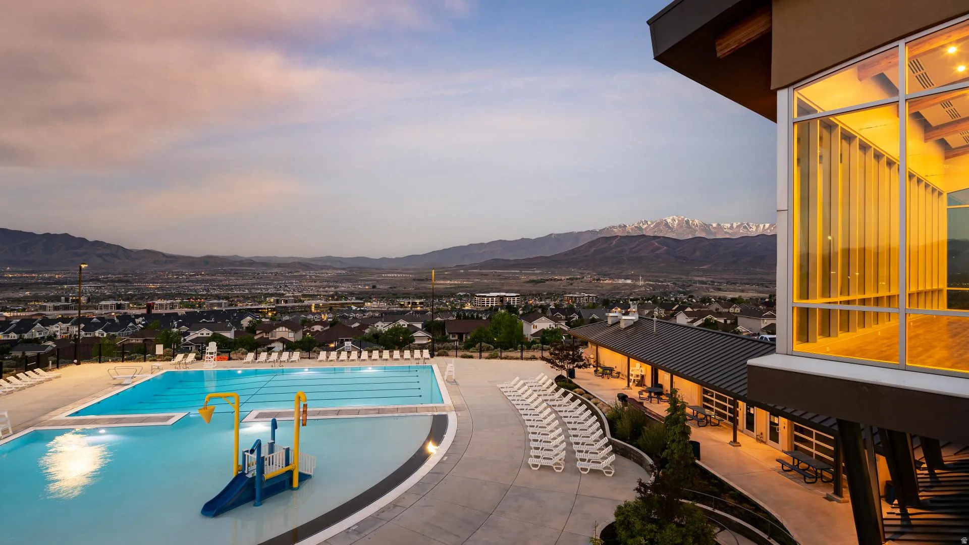 HOA Amenities Expansive outdoor pool area featuring a multi-lane swimming pool and a shallow water play structure