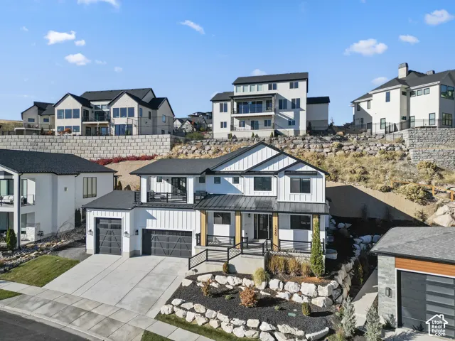 Contemporary two-story residence with white vertical siding and black trim accents
