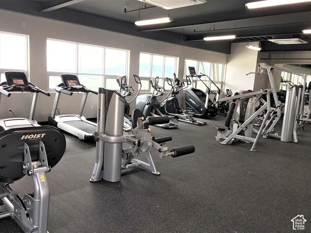 HOA Amenities Fitness center featuring multiple treadmills, elliptical machines, and strength training equipment