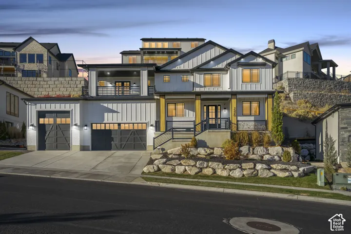 Contemporary home featuring board and batten siding with stone accents
