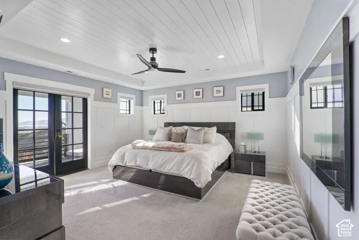 Spacious primary bedroom suite with vaulted shiplap ceiling, ceiling fan, and recessed lighting throughout