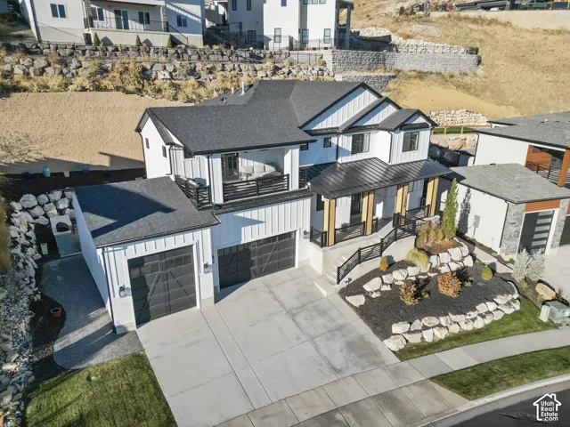 Contemporary home featuring white board and batten siding with black trim accents