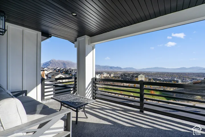 Covered outdoor balcony with mountain and distant water scenery