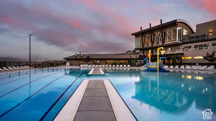 HOA Amenities Expansive outdoor pool area with multiple swimming lanes and a built-in water play structure
