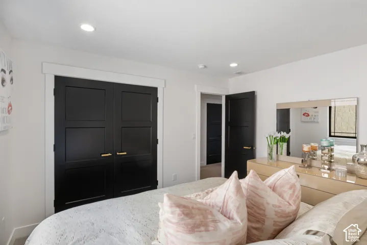 Recessed lighting illuminates the space, featuring white walls and trim throughout
